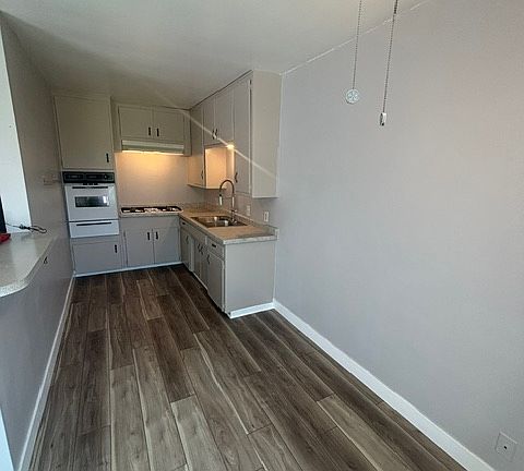 Spacious eat-in kitchen with vinyl plank flooring and new paint