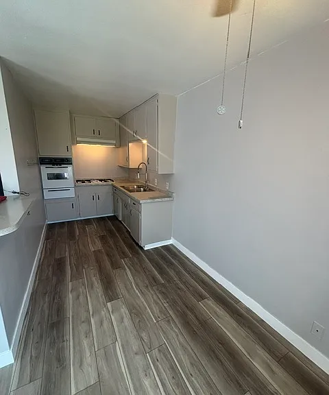 Spacious eat-in kitchen with vinyl plank flooring and new paint