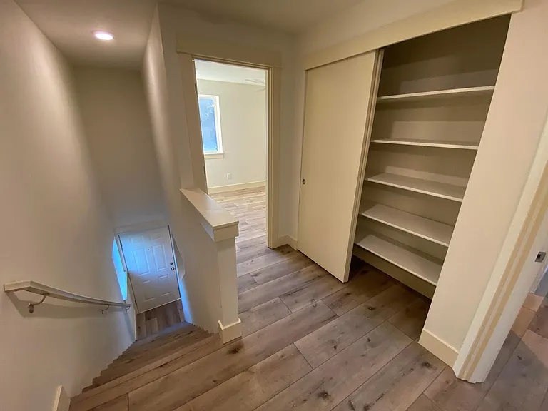 Top of stairs looking into linen closet & second bedroom