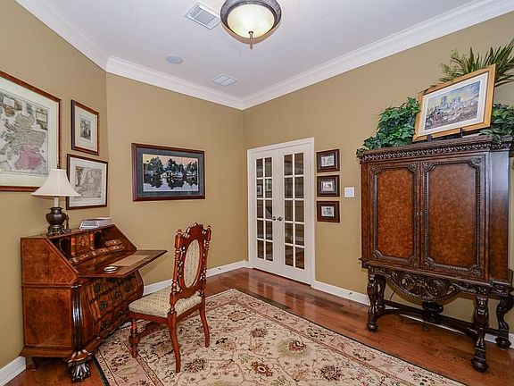 French doors lead into this study with lovely crown molding.