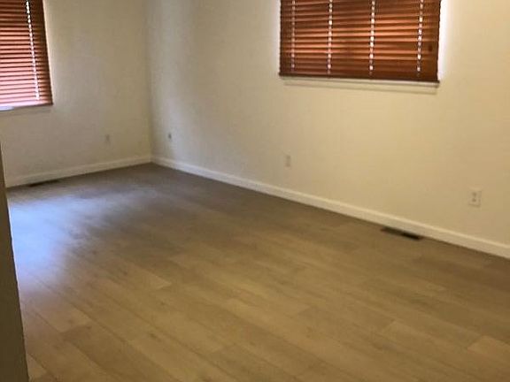 Spacious living room with ceiling fan