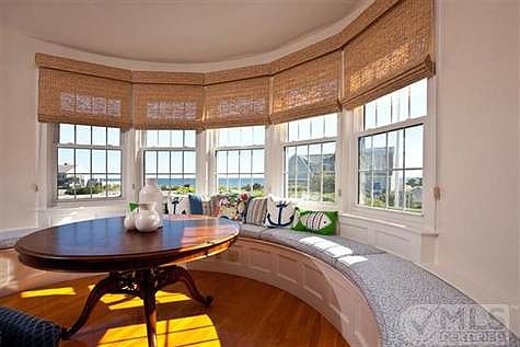 half moon window seat in living room with views of the ocean.