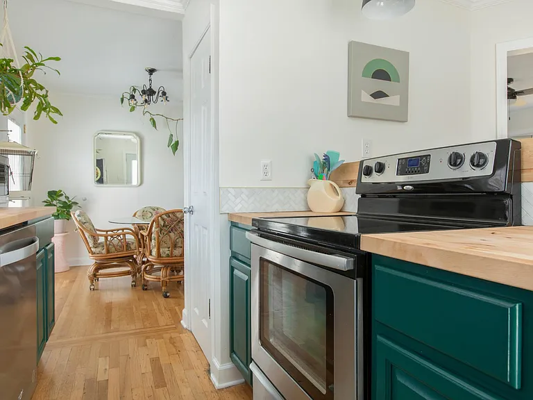 View of kitchen into dining area. Pantry door is visible.