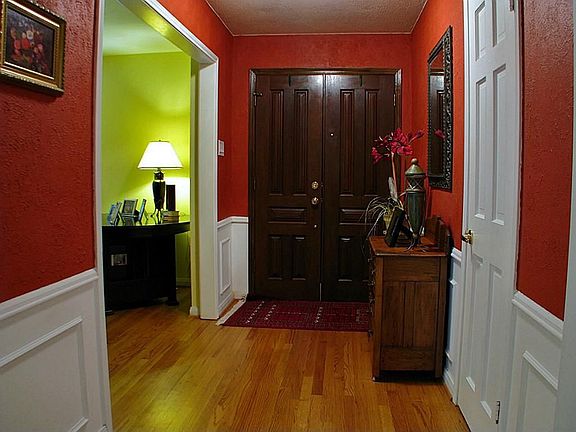 A large entry foyer leads past the formal living and dining rooms to an enormous den!