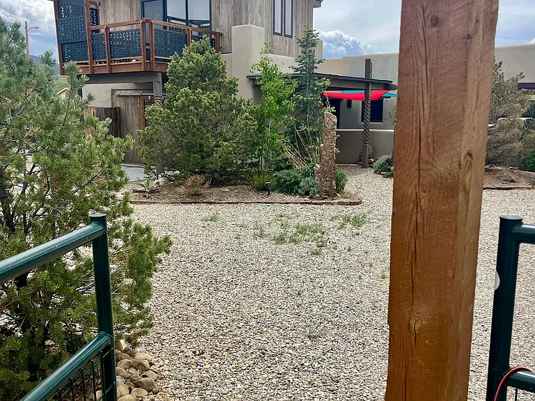 View of the charming Southwest style home as you enter from the private fenced in yard where you park.