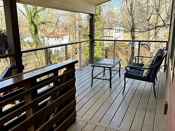 Comphy porch with a birds eye view. Room to grill!