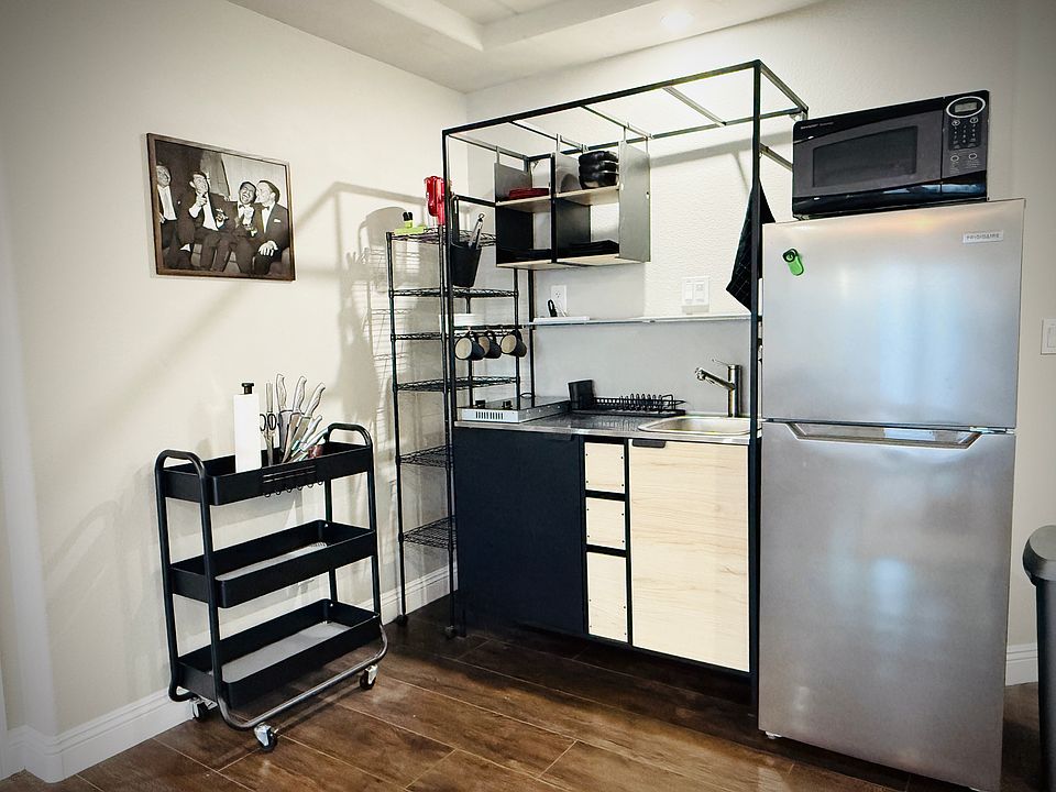 The kitchenette has it all. Microwave, Fridge, Freezer, Pots/Pans, Dual Burner Cooktop, Utensils, Cutting Board, Sink, Extendable Faucet, Garbage Disposal, 
Shelving, Blender, Knives, and of course Dishes.