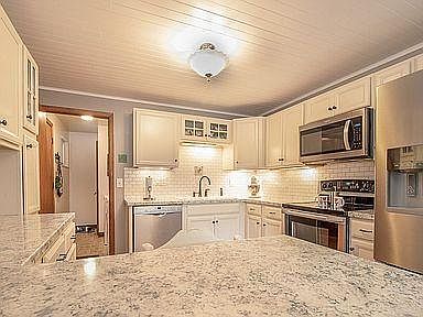 Updated kitchen with DW, garbage disposal, microwave, stove, and refrigerator.