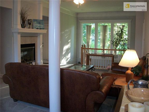 Great room with fireplace, ceiling fan, amazing windows and see-through fireplace.