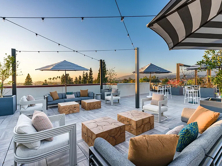 Experience the rooftop deck at Modera Pomona with stunning views, cozy seating, and the perfect space to relax or entertain.