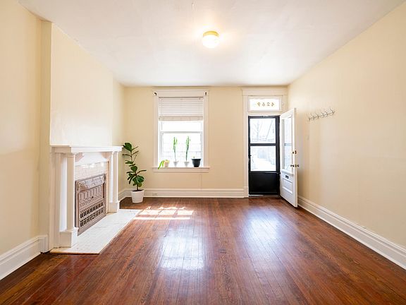 Front room has great light and non-functional fireplace