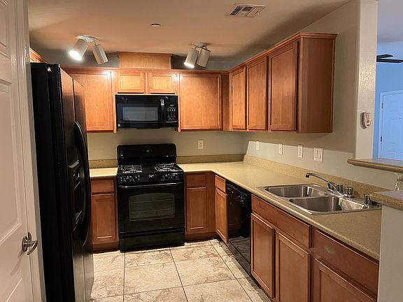 Kitchen with microwave, stove/oven, dishwasher, refrigerator and pantry.