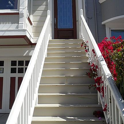Front stairway leading to gorgeous custom mahogany front door