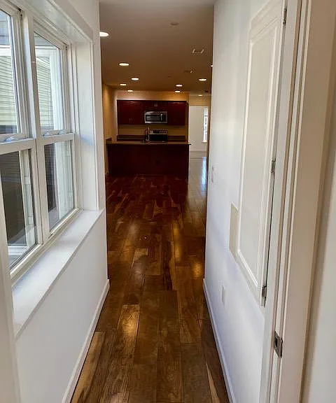 Hallway from front bedroom to living area and kitchen