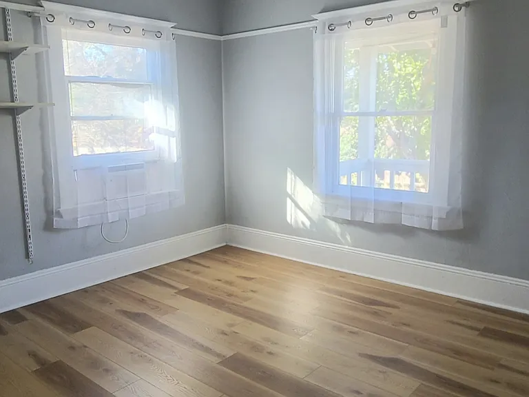 Newly installed flooring in the master bedroom. Ceiling fans throughout the home.
