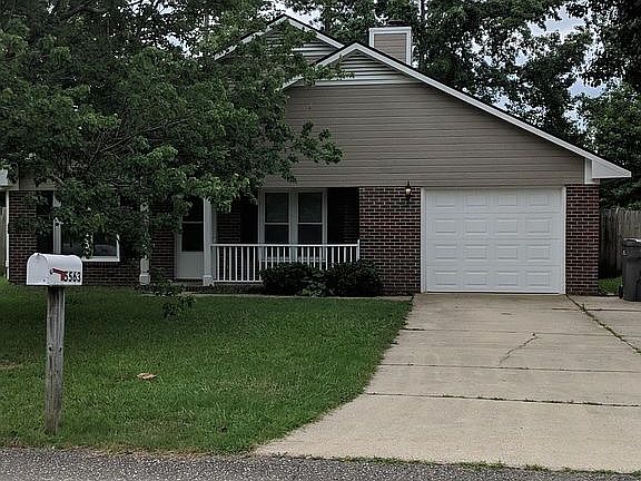 Street view. Single car garage with parking pad. 
