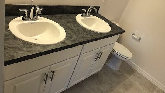 Double vanity in the master bathroom with beautiful white ca