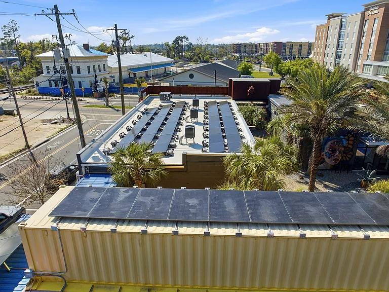 The panels in the foreground power a battery that allows one apartment to operate off grid.