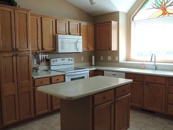 Kitchen has been updated with solid surface Corian countertops, and additional cabinetry