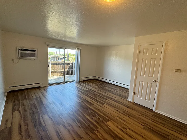 Living room with new A/C and new LVP.