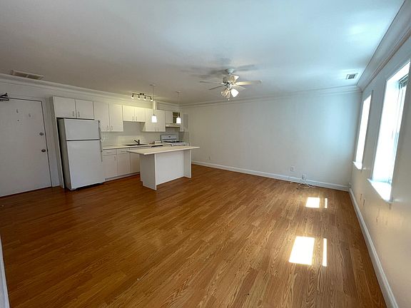 Spacious Kitchen and living area with center island in kitchen
