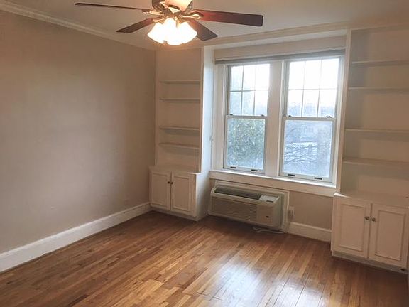 Living room built-in shelves and sunny west-facing views