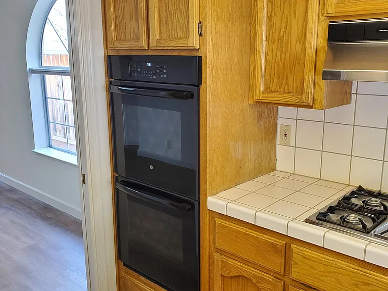 Kitchen considering the range stove, solid wood cabinetry.