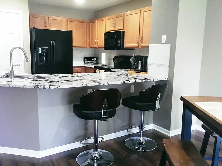 large granite counter with adjustable bar stools