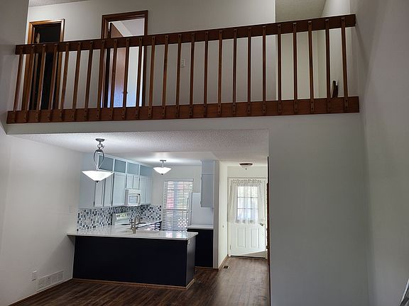 Living room area has vaulted ceiling