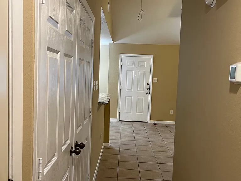 washer and dryer on left, front door ahead