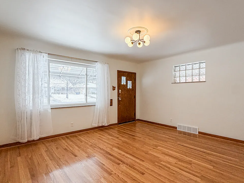 Bright living space with refinished hardwood floors