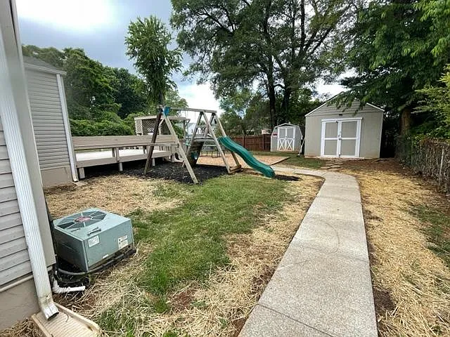 Rear yard with 2 storage units. The playground set has been removed.