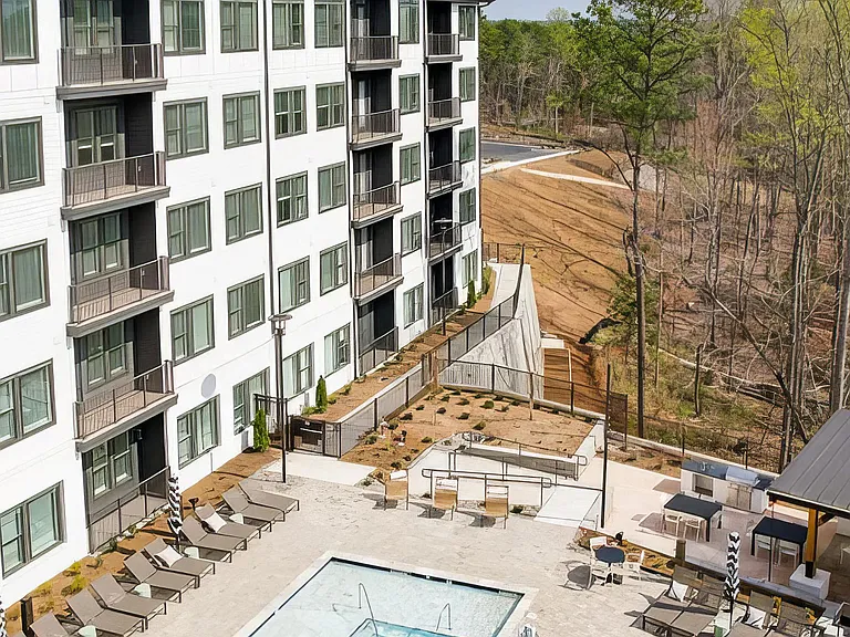 Large outdoor saltwater pool with deep and shallow areas and lounge seating