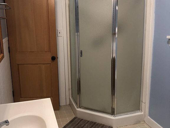 Separate shower and solid wood doors throughout.