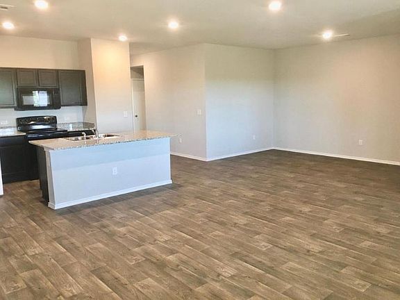 Looking at the back of the living room toward the kitchen/dining area