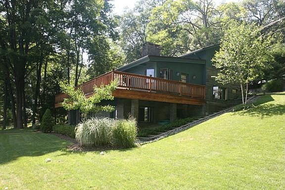 View of Home w/ Deck overlooking lake