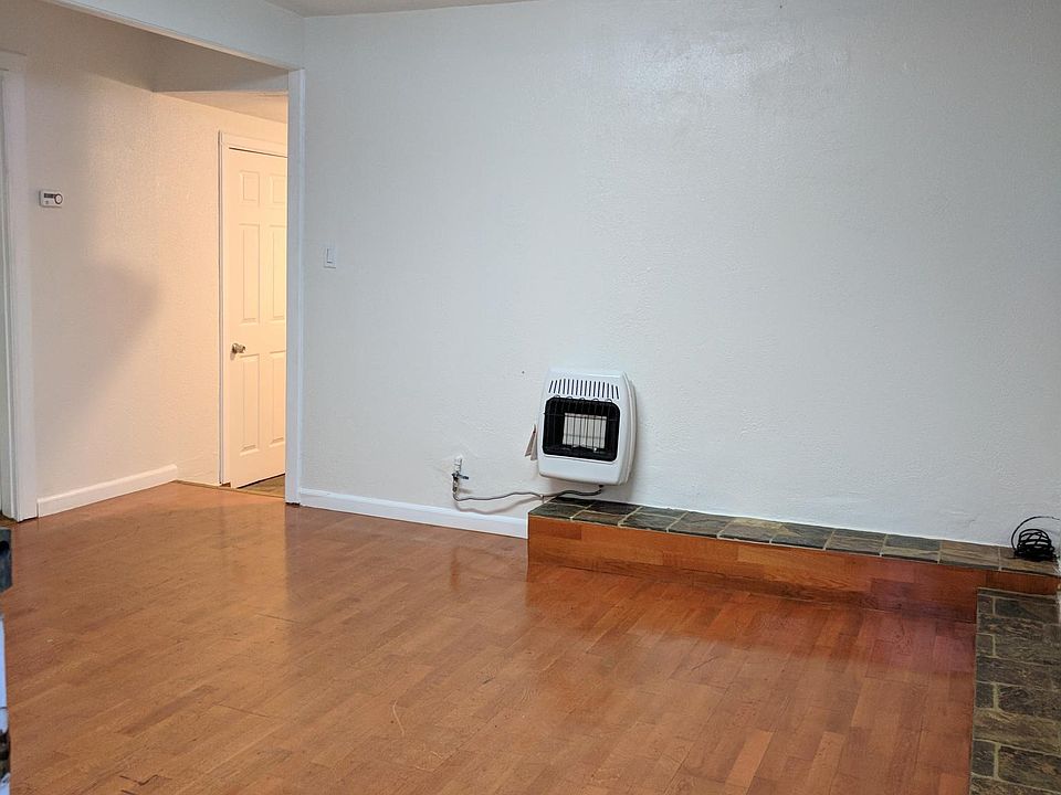 living room with new heater with hardwood floor