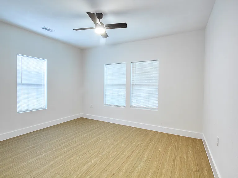 Primary bedroom, no carpet, ceiling fan, led lighting