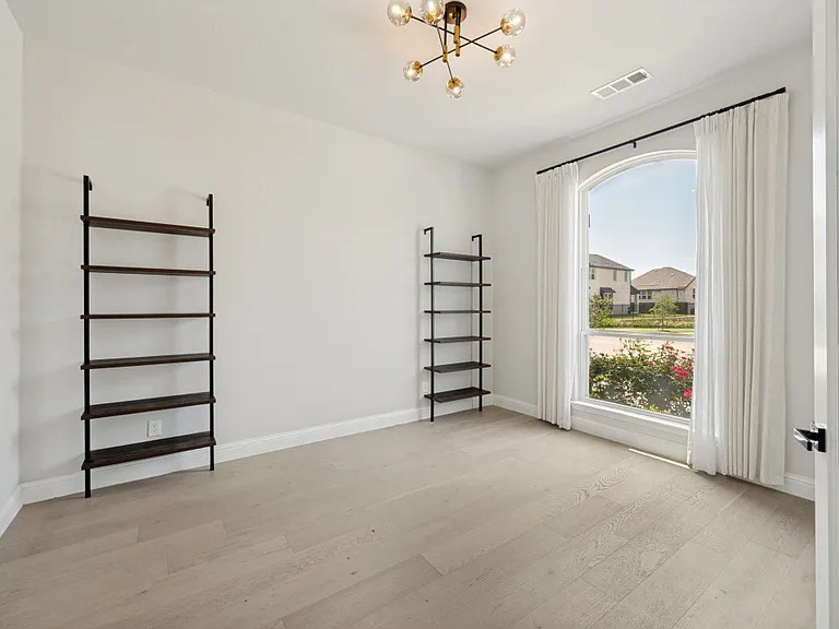 HUGE private home study with french doors. Owners installed wood flooring and the attached shelving. Just repainted