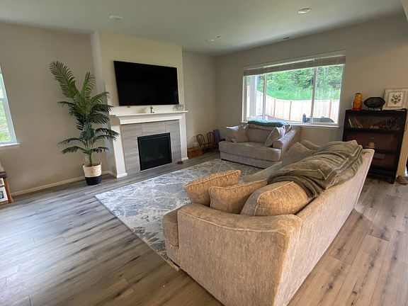 65" smart tv, soft luxurious couches, gas fireplace, and more relaxing forest views.