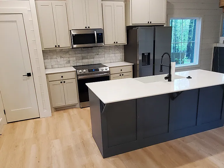 Fully-equipped kitchen with stove/oven, microwave, refrigerator / freezer, and dishwasher.
