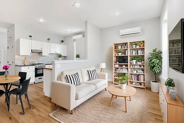 The common spaces are on the lower level of the bi-level apartment. The large space with 10' ceilings is flooded with natural light and boasts exposed brick and oak floors.