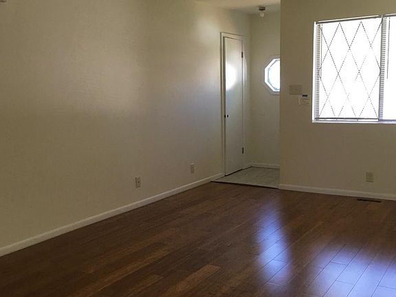 Tiled entryway and hardwood flooring in the living room.