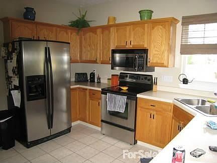 Kitchen : Stainless Steel appliances with Ceramic flooring in kitchen and foyer