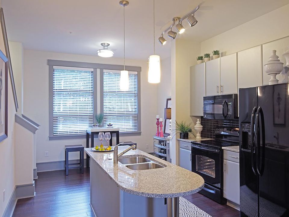 Kitchen with silver cabinets and granite countertops