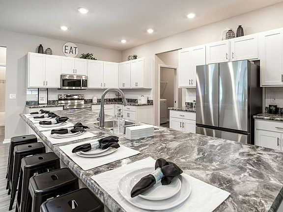 Enjoy a bright, open kitchen with an oversized counter-height island that can easily seat 6 - Summer