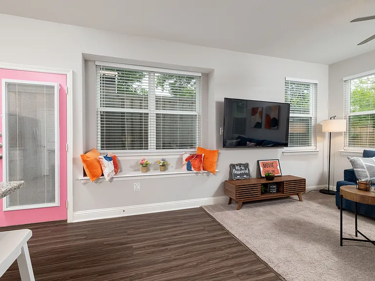 Spacious open living room with two comfy couches and a large flat-screen TV_perfect for relaxing nights in or movie marathons.