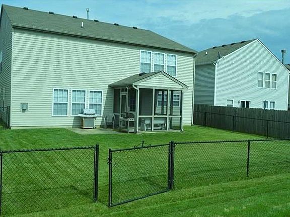 Exterior Back. Nice back yard with full fenced rear. Covered screened patio, plus added patio pad.