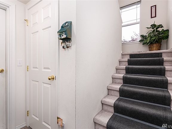 From entrance, stairs lead up to Unit 2 on top floor.  Door to garage on left, with closet/storage under the stairs.  