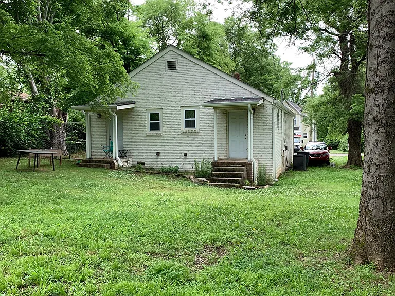 View of back entrance and porch from rear of yard.